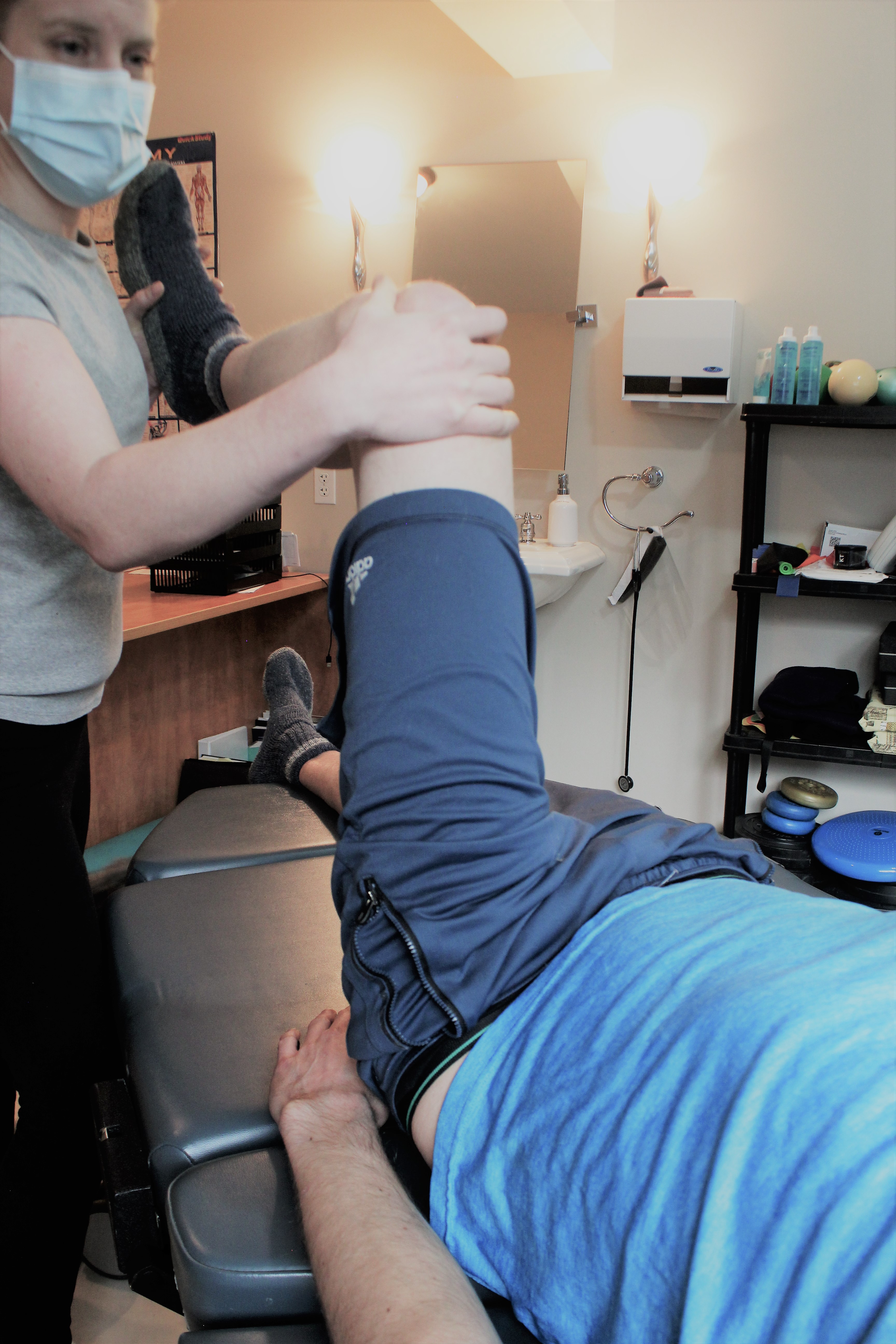 physiotherapist working on male knee
