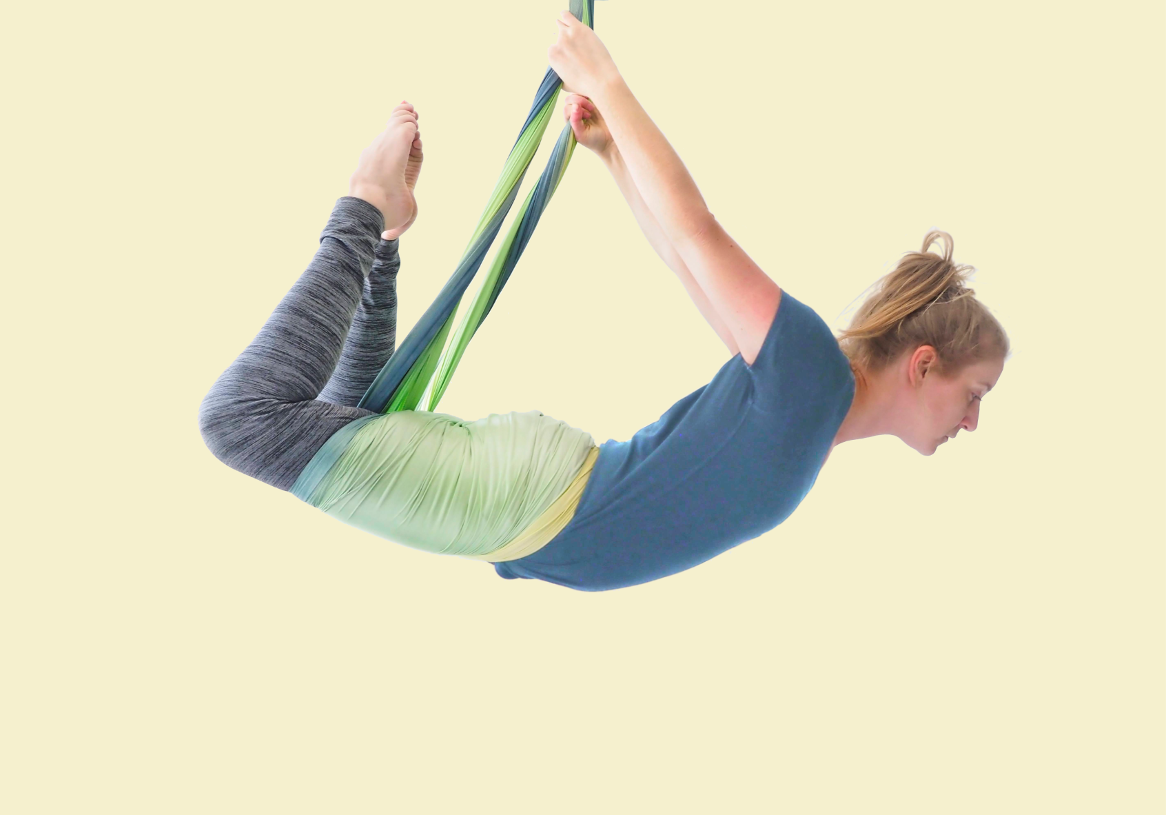 Woman practicing yoga in an aerial yoga sling